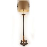 A floor standing Empire standard lamp in bronze and gilt, supported on triform lions paw feet, 205cm