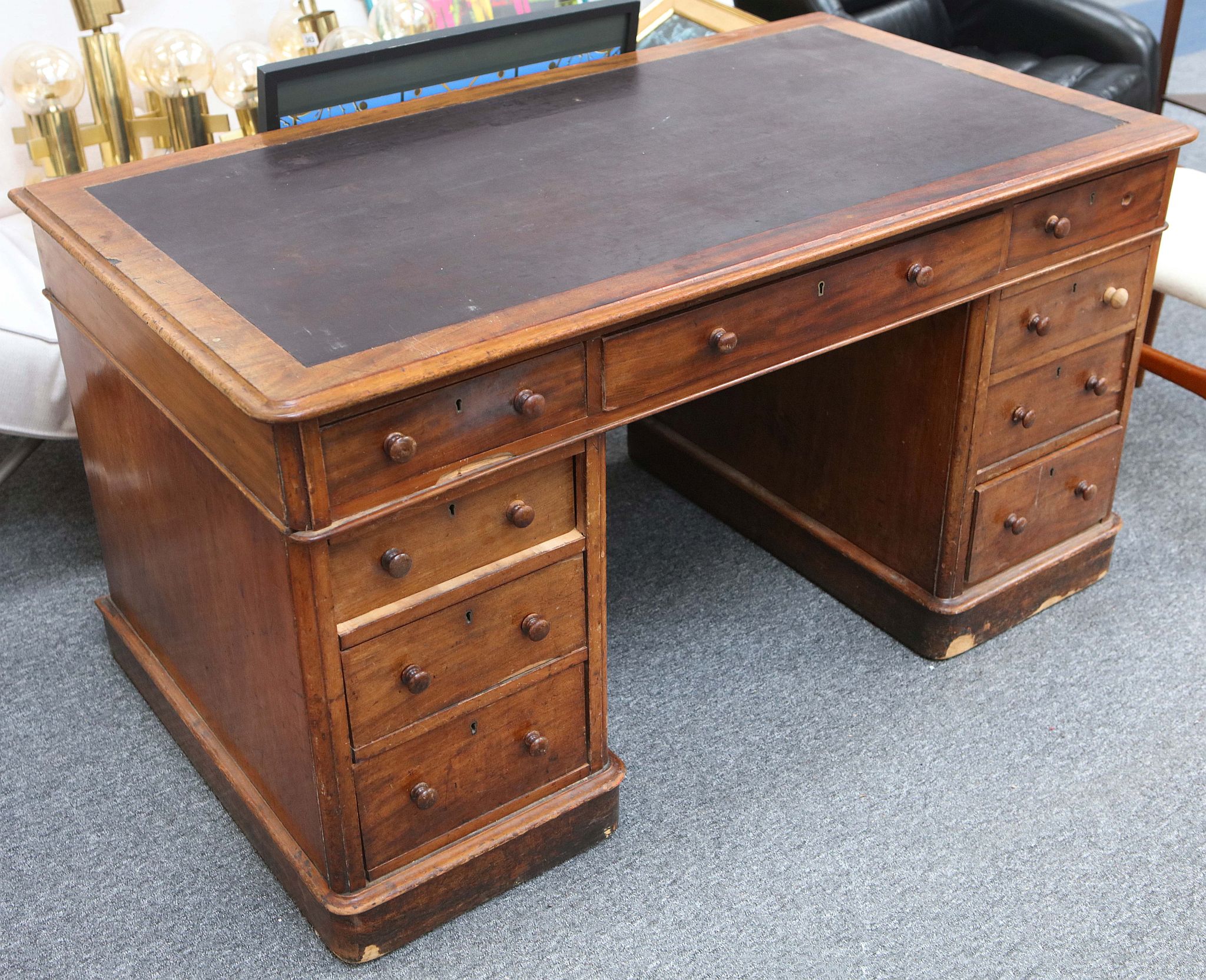 An early 20th Century mahogany pedestal desk with inset black leather top.