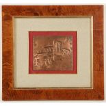 A copper embossed panel, indistinctly signed and dated '86, depicting a medieval town with bridge,