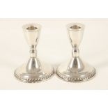 A pair of late Art Deco Sterling silver desk candlesticks, raised on circular bases, marked to