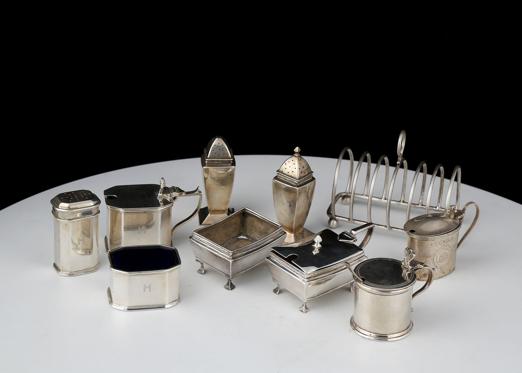 A mixed lot of Antique Sterling Silver items to include an Art Deco Octagonal three piece cruet