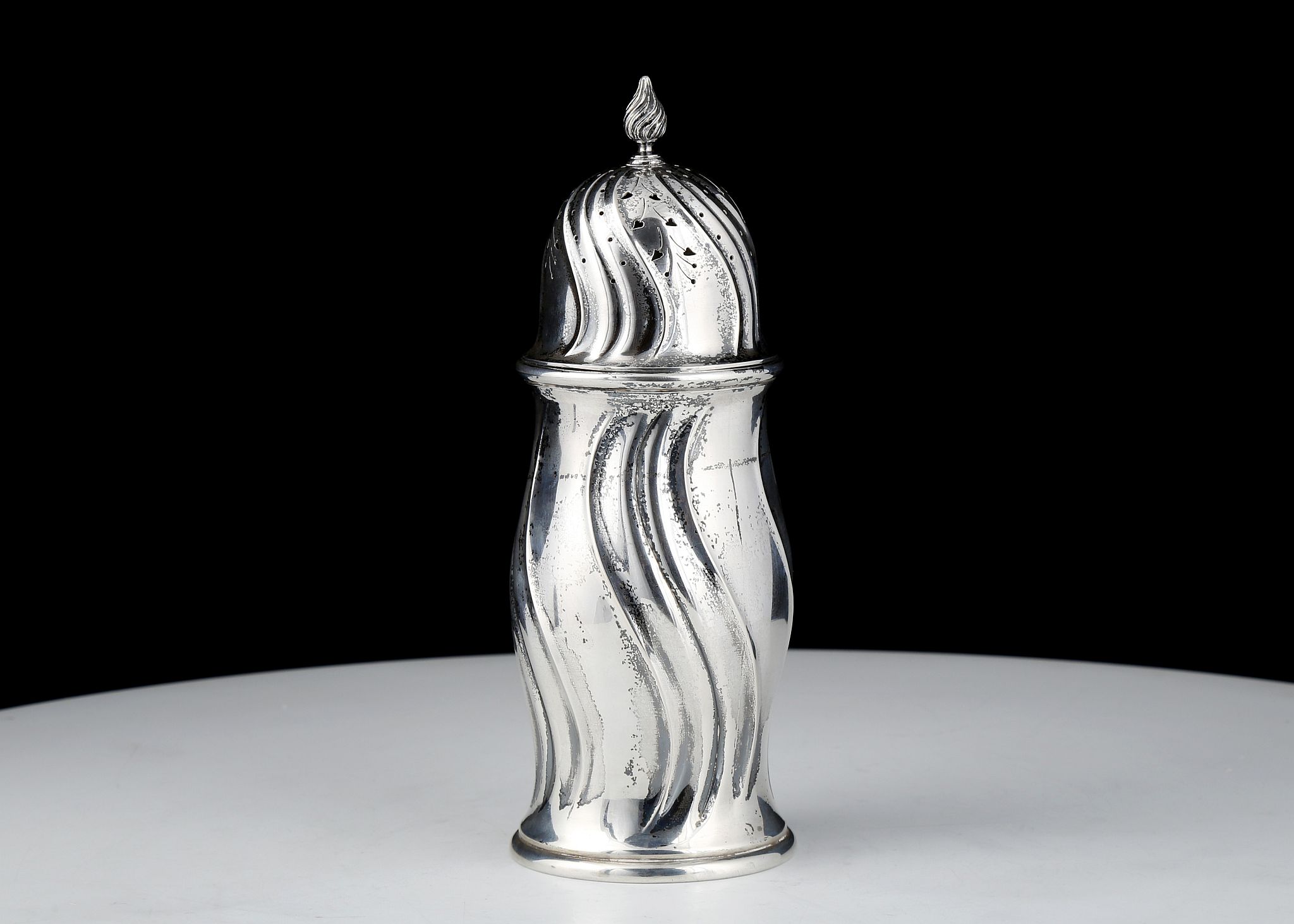 Antique Danish Sterling Silver sugar castor marked Copenhagen, 1917. The shaped body with undulating