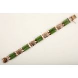 A vintage Chinese jade and gold bracelet c.1950, the curved two two nephrite bars with yellow gold