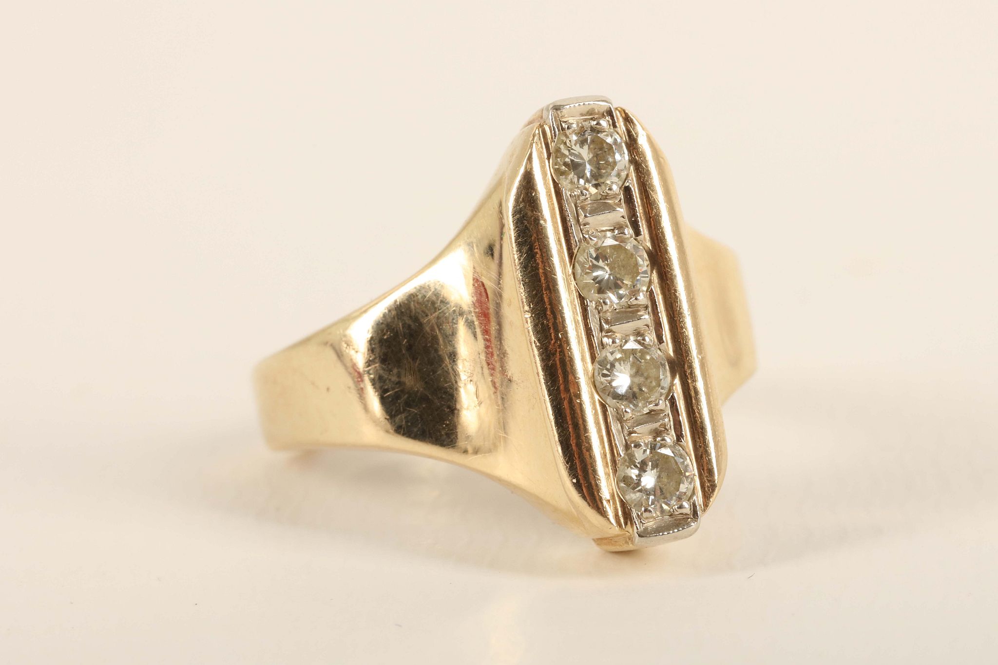 A diamond and yellow gold dress ring, the lozenge shaped top set with four uniform sized brilliant