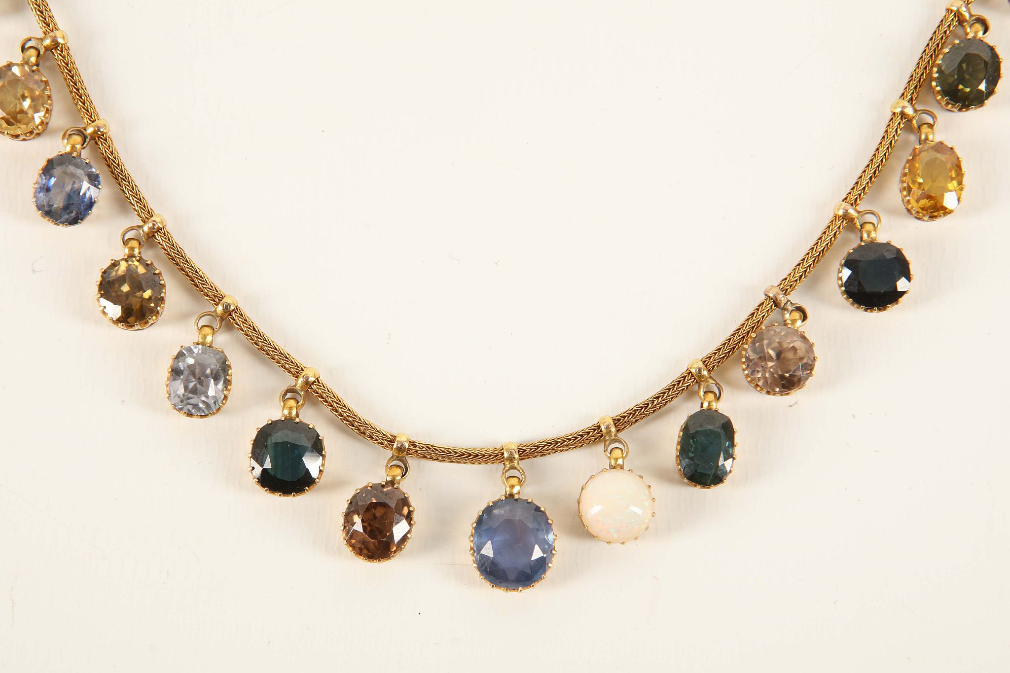 A c.1900 gold and multi gem necklace, the fox tail chain loop mounted with twenty one claw set gem - Image 2 of 3