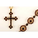 An 18ct gold and garnet cluster bracelet, the pierced shield clusters set with round cut stones