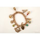 A vintage 9ct yellow gold charm bracelet, the hollow curb link bracelet with heart shaped clasp, ten