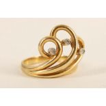 An 18ct gold and diamond set wave scoll dress ring. Size: N. 6.36g,
