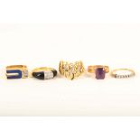 A group of five various yellow gold and gem set dress rings, including a black onyx and diamond band