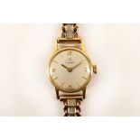 A 1970's 18ct gold ladies wristwatch by Tissot, on a flexible 9ct yellow gold curb link and box line