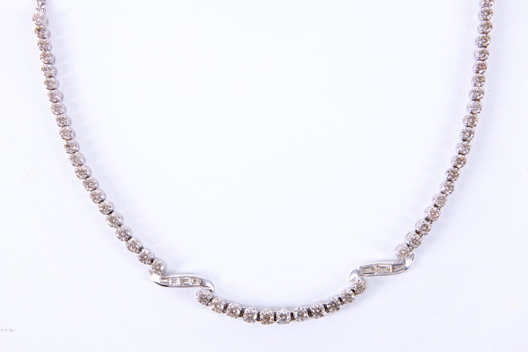 A 14ct white gold and diamond set necklace, the 53 graduated brilliant round cut stones interspersed