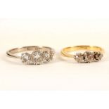 A diamond graduated brilliant cut three stone ring, mounted in 18ct white gold and platinum, and