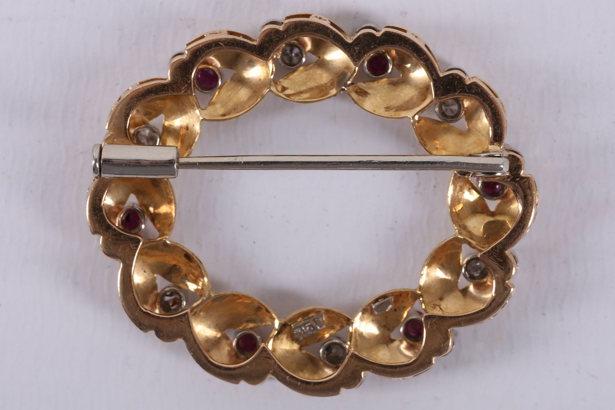 An 18ct gold foliate wreath brooch, the leaves interspersed with claw set diamond and ruby pairs. - Image 2 of 2