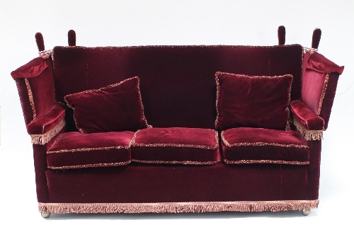 A Knole settee and two armchairs in red velvet, the settee 177.