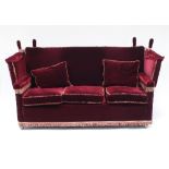 A Knole settee and two armchairs in red velvet, the settee 177.