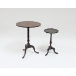 A mahogany table on a turned column and tripod support, 52cm diameter and a black,