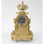 A French gilt metal mantel clock, the circular dial with enamelled Roman numerals,