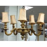 A giltwood five-light electrolier with carved surmount