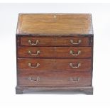 A late 18th Century mahogany bureau, having a central cupboard door,