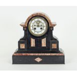 A late 19th Century eight-day black and variegated pink marble mantel clock, fitted a white enamel