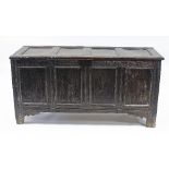 An 18th Century oak chest with four panels to the hinged cover,