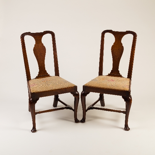 A pair of George I walnut side chairs, with vase shaped splats,