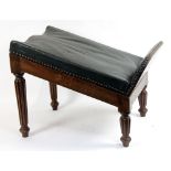 A Regency mahogany gout stool, the adjustable upholstered rest on turned reeded legs,