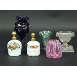 Two similar opaque glass scent bottles each painted with bands of flowers,