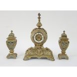 A French brass mantel clock and urn garniture, the circular dial with Arabic numerals,