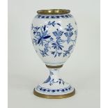 A Continental blue and white porcelain urn, decorated with stylised blue flowers on a white ground,