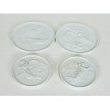 Two pairs of parian porcelain circular plaques, the largest pair moulded with birds in foliage,
