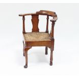 A George II walnut corner chair with cabriole legs