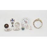 A Derby rose painted taper stick, a cylindrical jar and cover, a trumpet vase, a Coalport vase,