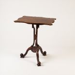 A George III style rosewood tripod table with serpentine rectangular top,