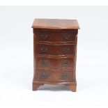 A small mahogany serpentine front chest of four long drawers on bracket feet, 49cm wide Condition
