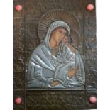 A Russian icon depicting mother and child, set with four coral coloured cabochon, 21.5cm x 16.