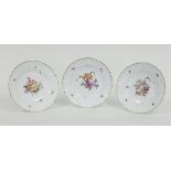 A set of three KPM porcelain plates painted with summer flowers, circa 1860/Provenance: Plas Gwyn,