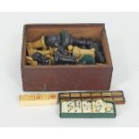 A Staunton type turned wood chess set lacking one pawn, together with a cribbage board,