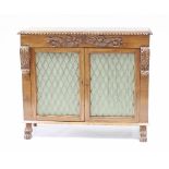 A Regency mahogany cabinet enclosed by a pair of doors with brass grilles,