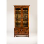 A George II walnut two-door cabinet, the later upper part with four shelves above a period five