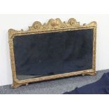 A Queen Anne carved and gilt gesso wall mirror, adapted to landscape, with shell carved cresting and