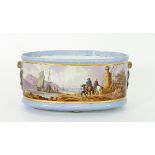 A Sarreguemines oval pottery jardinière painted with travellers on horseback with a port in the