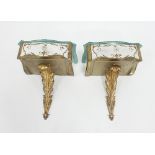 A pair of 20th Century mirrored console tables on leaf chased supports,