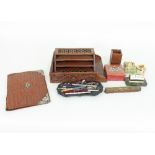 A small group of desk related items to include a carved wood letter rack, an onyx desk lighter,