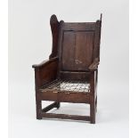 An 18th Century oak lambing chair with wing back and strung seat, 96cm high Condition Report: