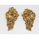 A pair of late 18th/early 19th Century carved gilt wood wall brackets, in the Rococo style carved