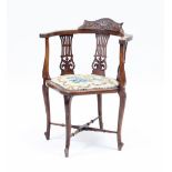 An Edwardian mahogany corner chair,