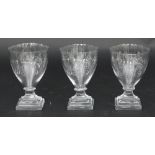 A set of three glass rummers, each engraved with monogram and crest,