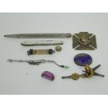 A miniature white metal sword and scabbard,