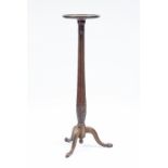 A mahogany torchère constructed from part of a Hepplewhite bedpost, now raised on tripod supports,